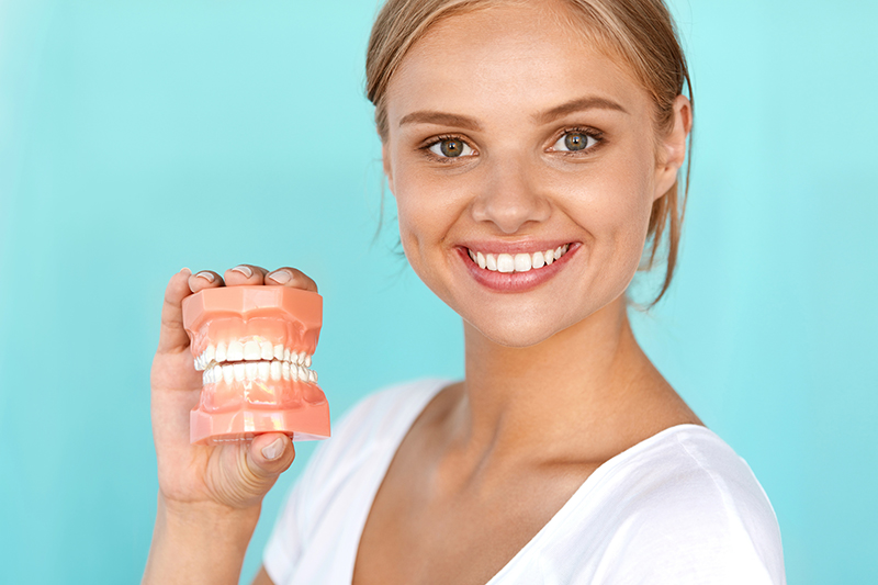 Woman holding teeth